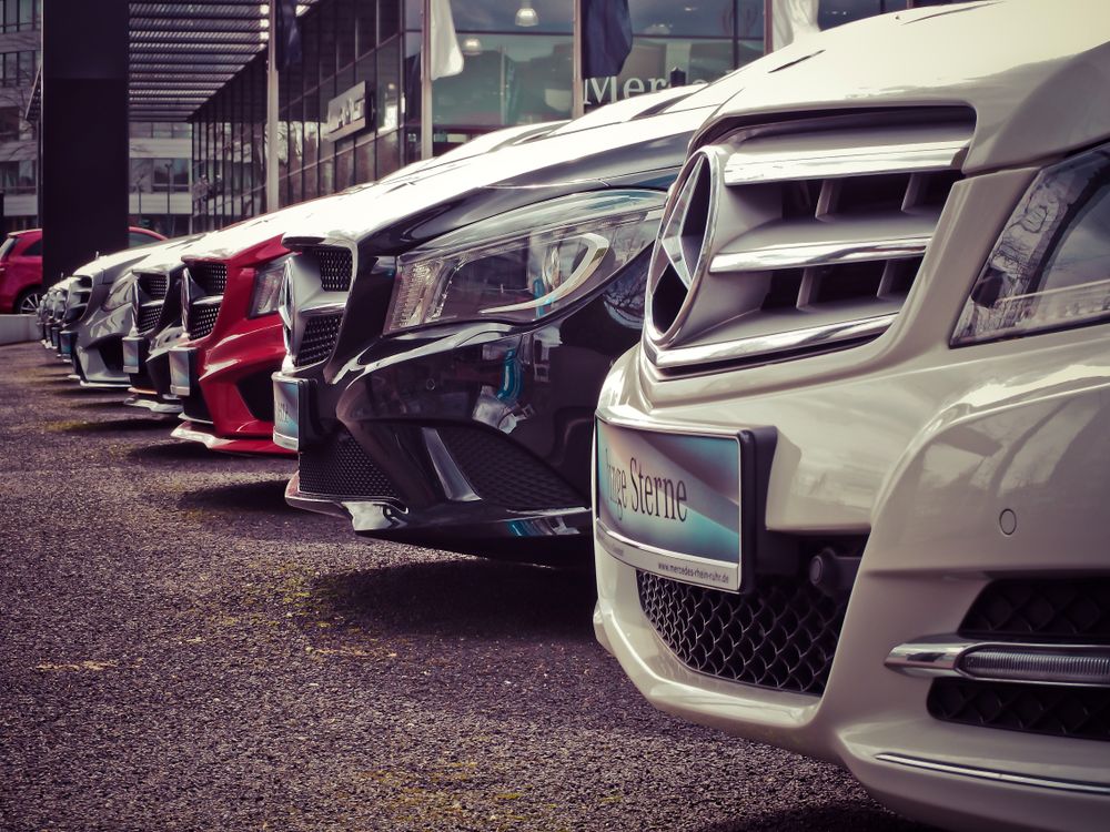 A close-up row of vehicles parked at the dealership lot