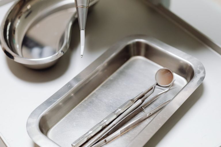 Dental instruments laid out on a steel tray