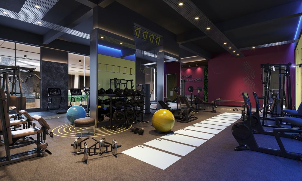 A modern gym floor with weights, benches and open training space