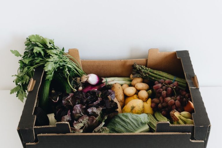 A box of fresh seasonal vegetables on a white background
