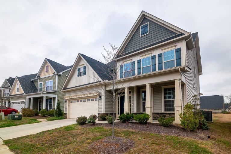 Large suburban family homes with garages and green lawns