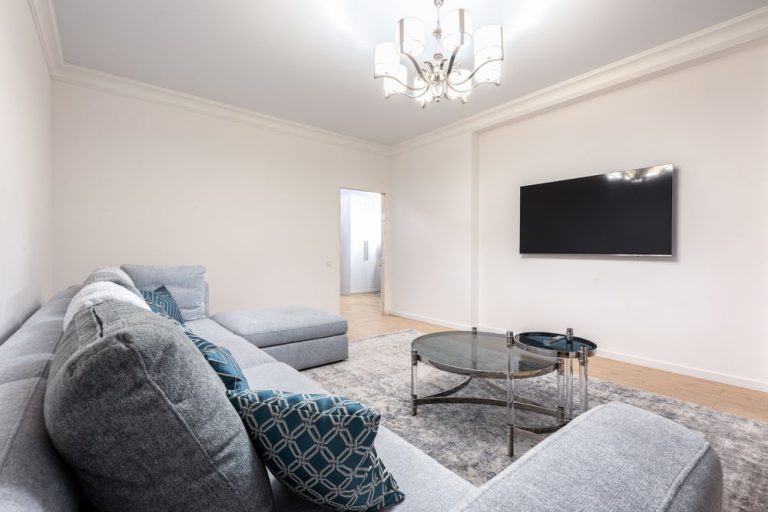 A bright living room with a grey sofa and a coffee table