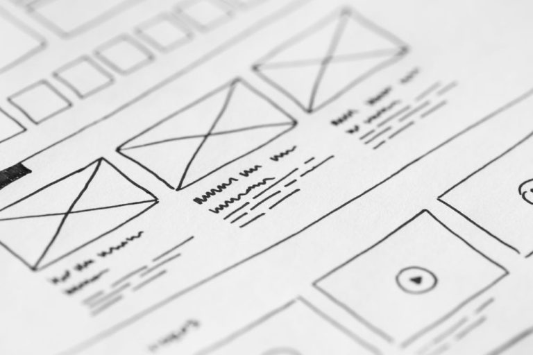 Hand-drawn website wireframe sketches on paper