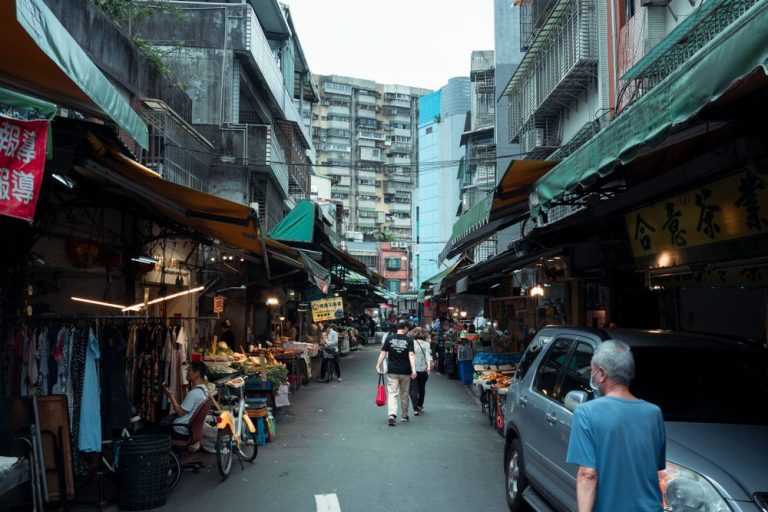 A busy street market lined with shops and stalls