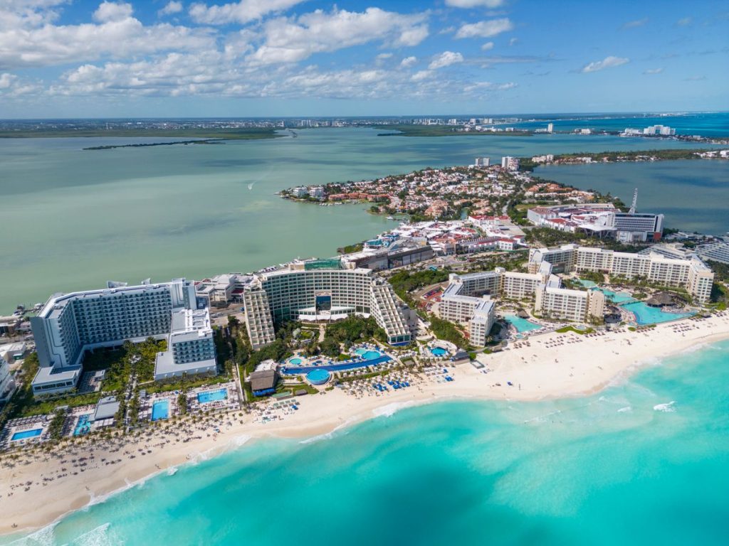 An aerial view of a resort town on a turquoise coastline