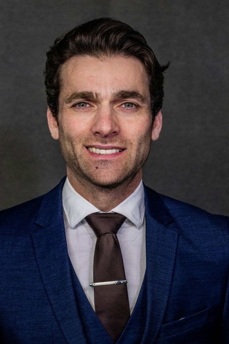 Jordan Lee, Managing Partner, in a navy three-piece suit