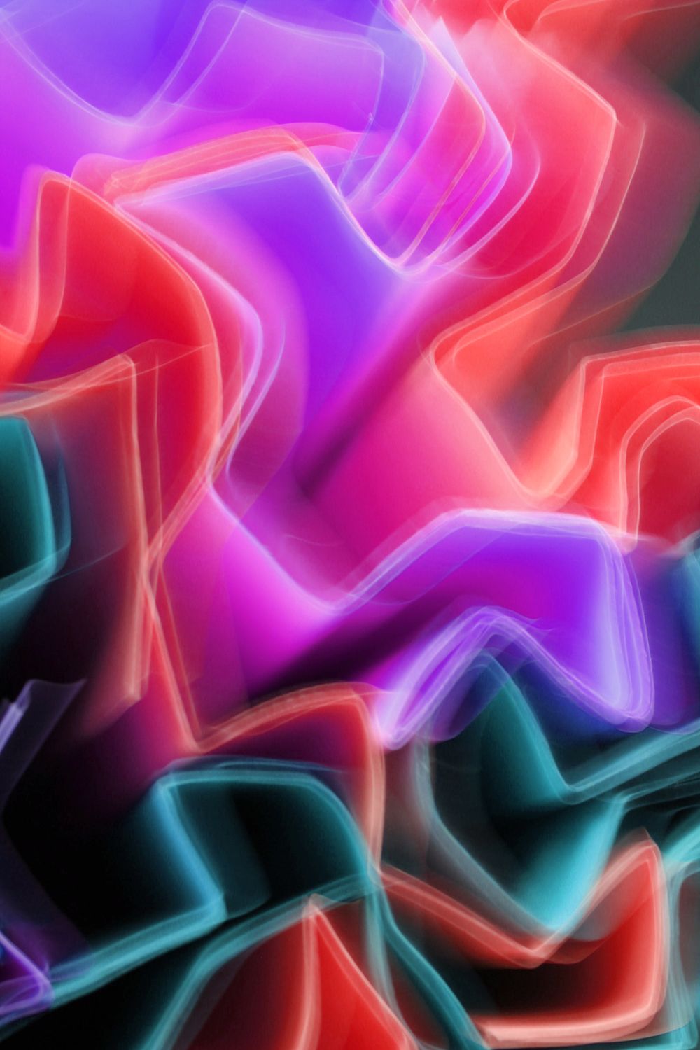 Abstract neon light forms in red, blue and violet on a black background