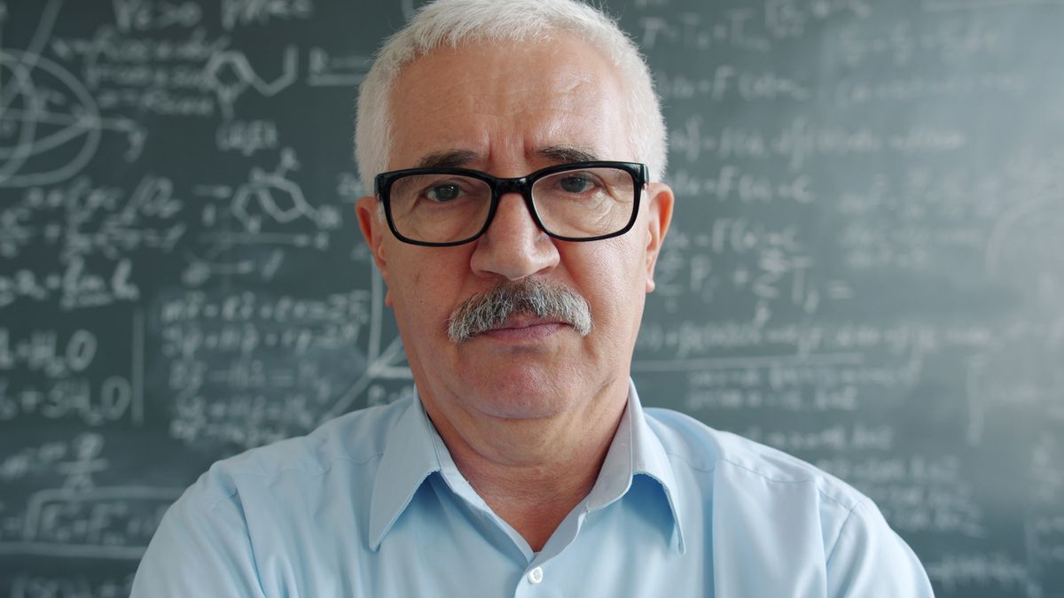 Professor Viktor Hale in front of a chalkboard covered with chemical formulae
