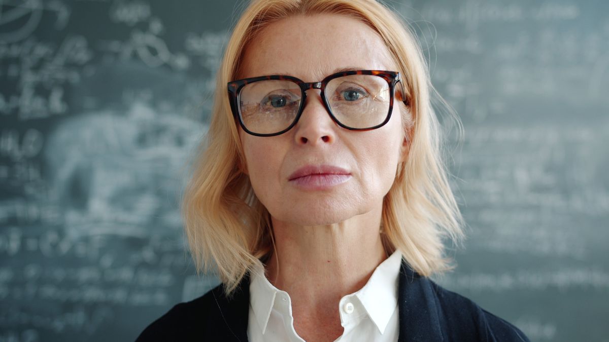 Dr Ingrid Solberg, Head of Humanities, in glasses in front of a chalkboard