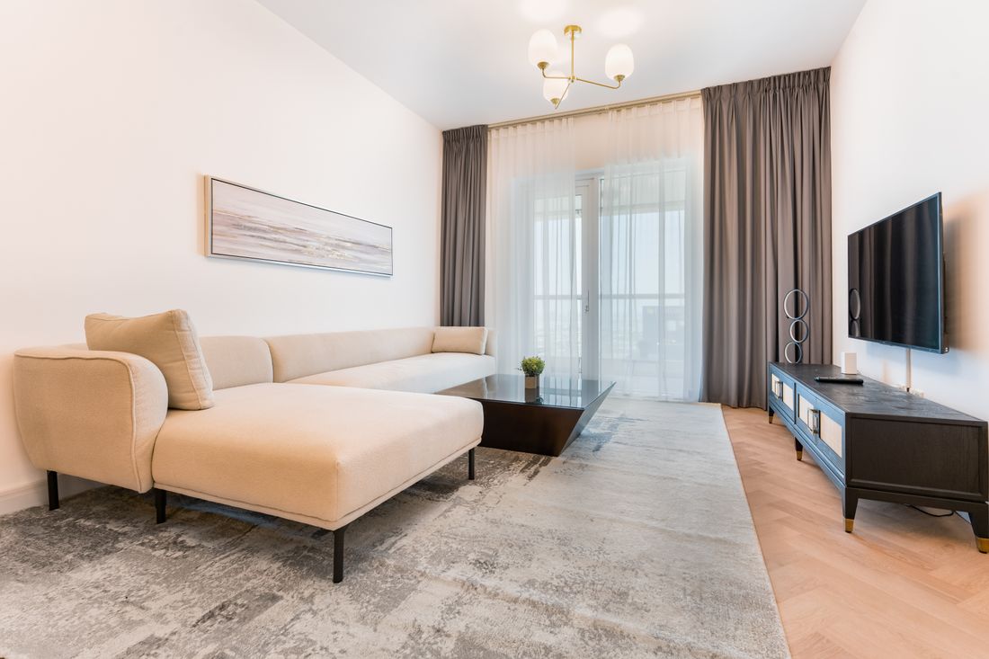 A bright open-plan living room with a cream sofa