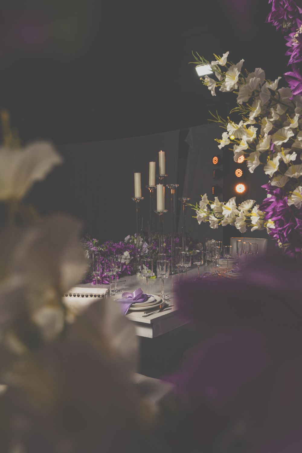 A candlelit table setting at an elegant wedding reception