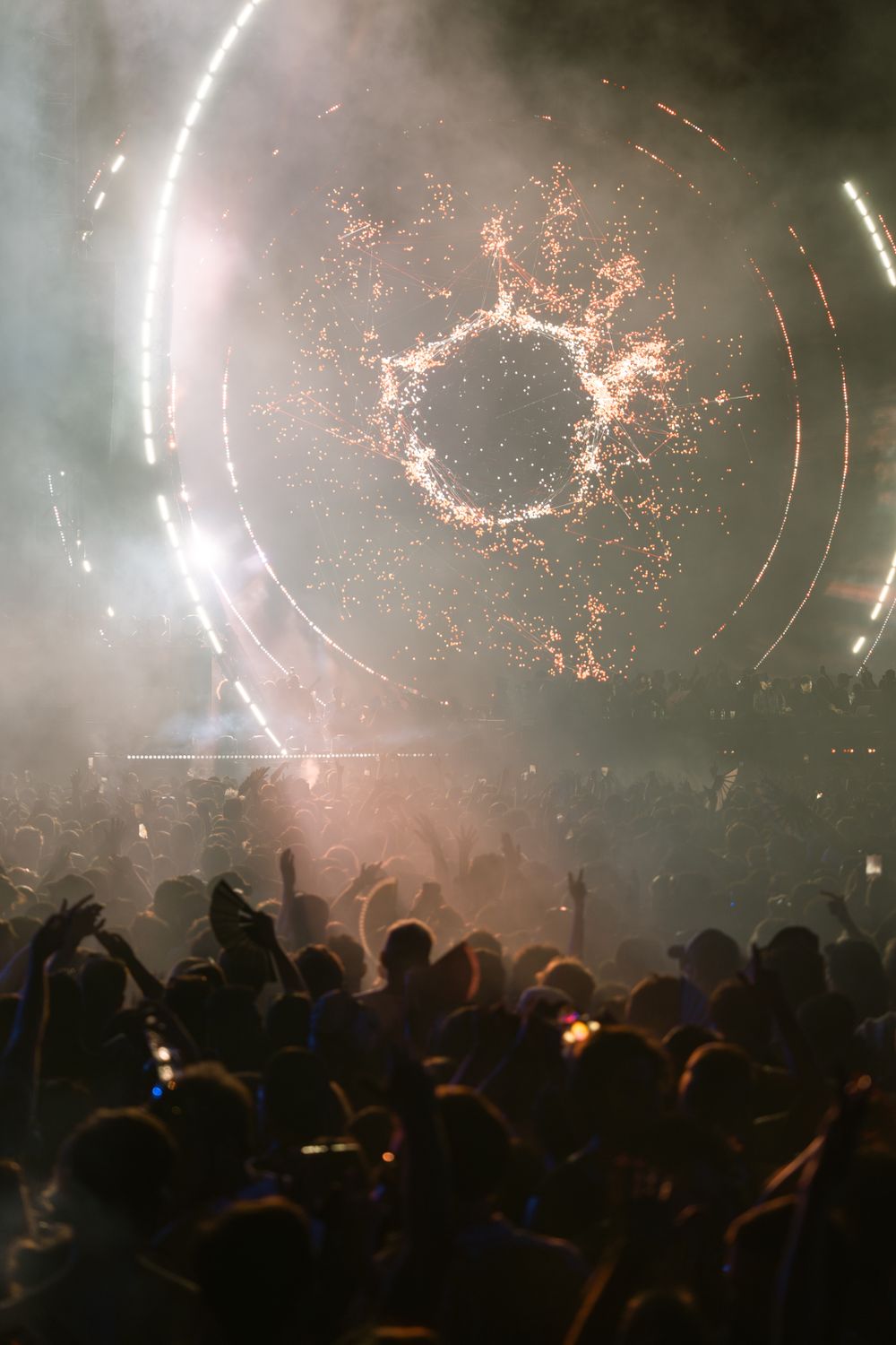 A large crowd at a nighttime outdoor music festival
