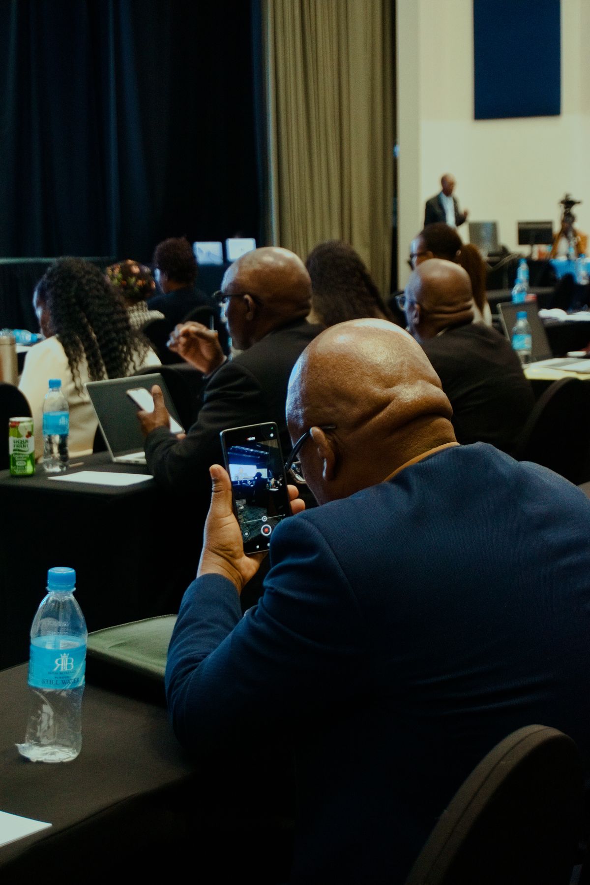 An audience engaging with a speaker at a business conference