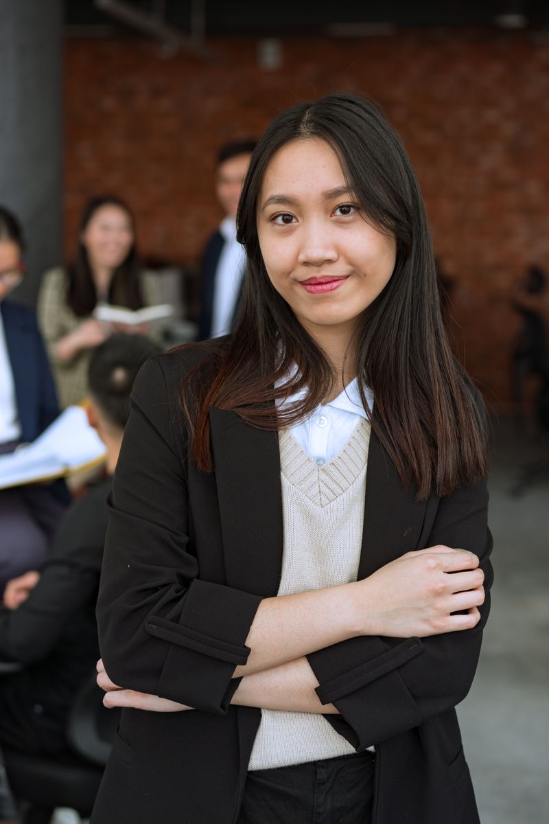 Mei Lin, Senior Planner, in a black blazer with folded arms