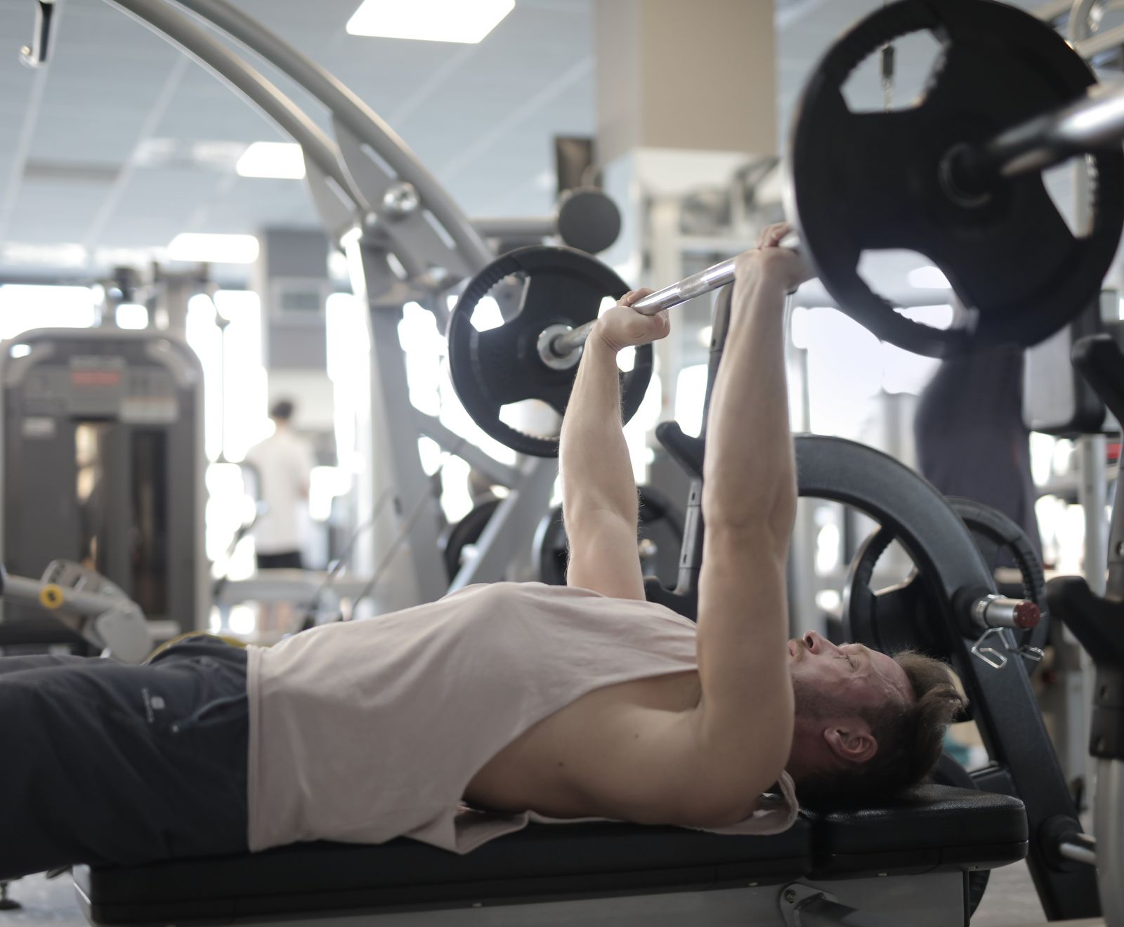 Athlete training with a barbell in a modern gym