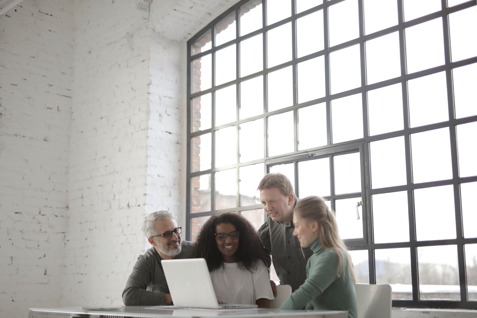 A small product team reviewing feature usage data together on a laptop