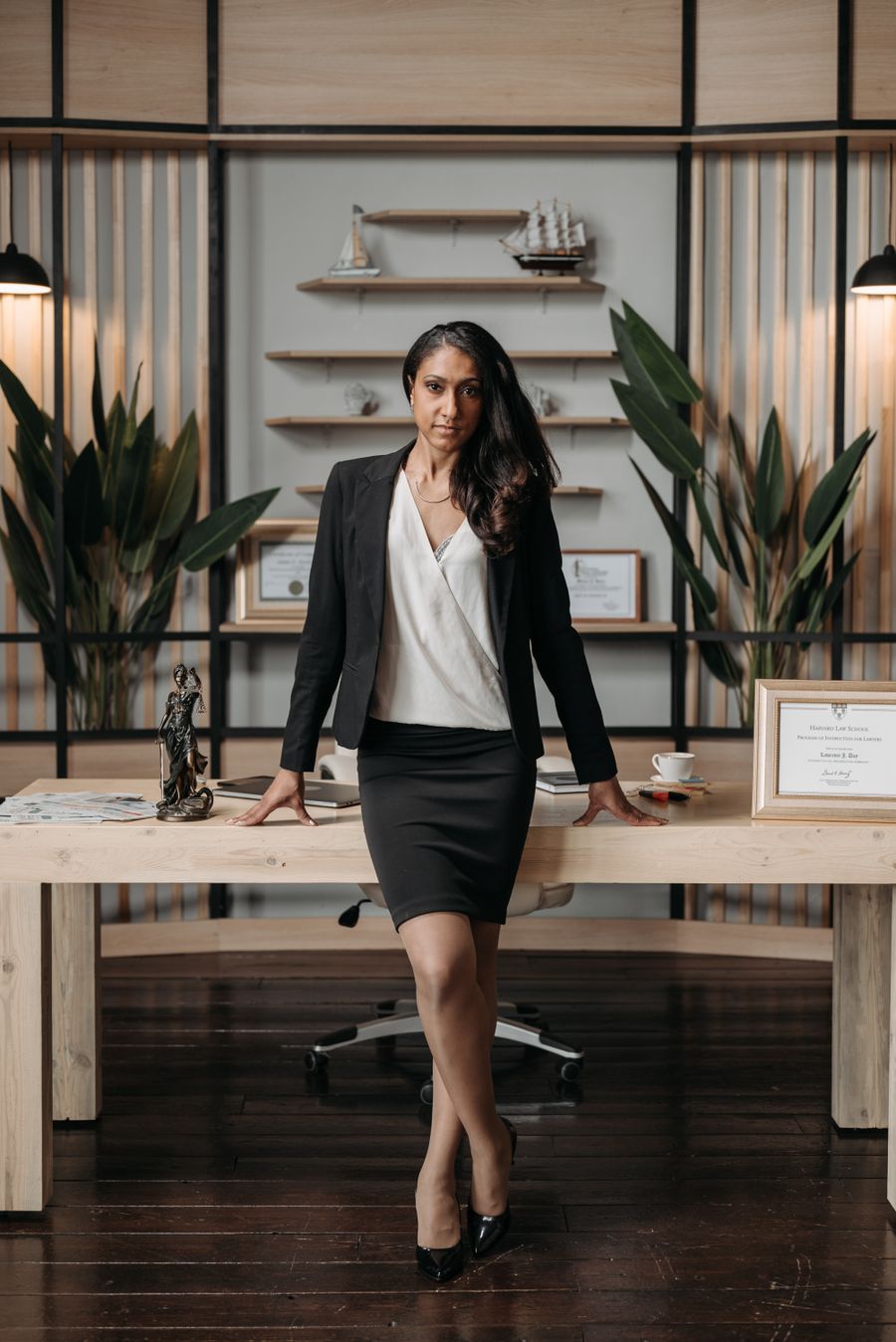 Elena Vasquez, Managing Partner, standing beside her desk in a black blazer