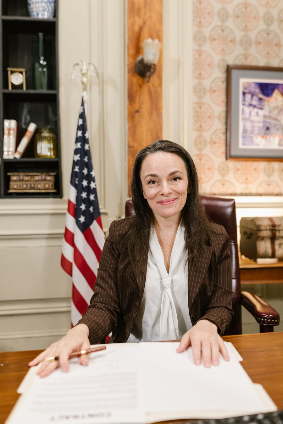 Claire Dubois, Partner, seated at her desk with case papers