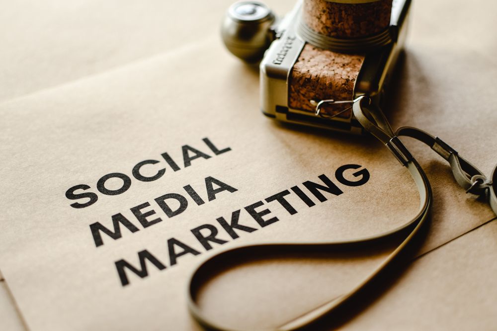Social media marketing lettering next to a vintage camera