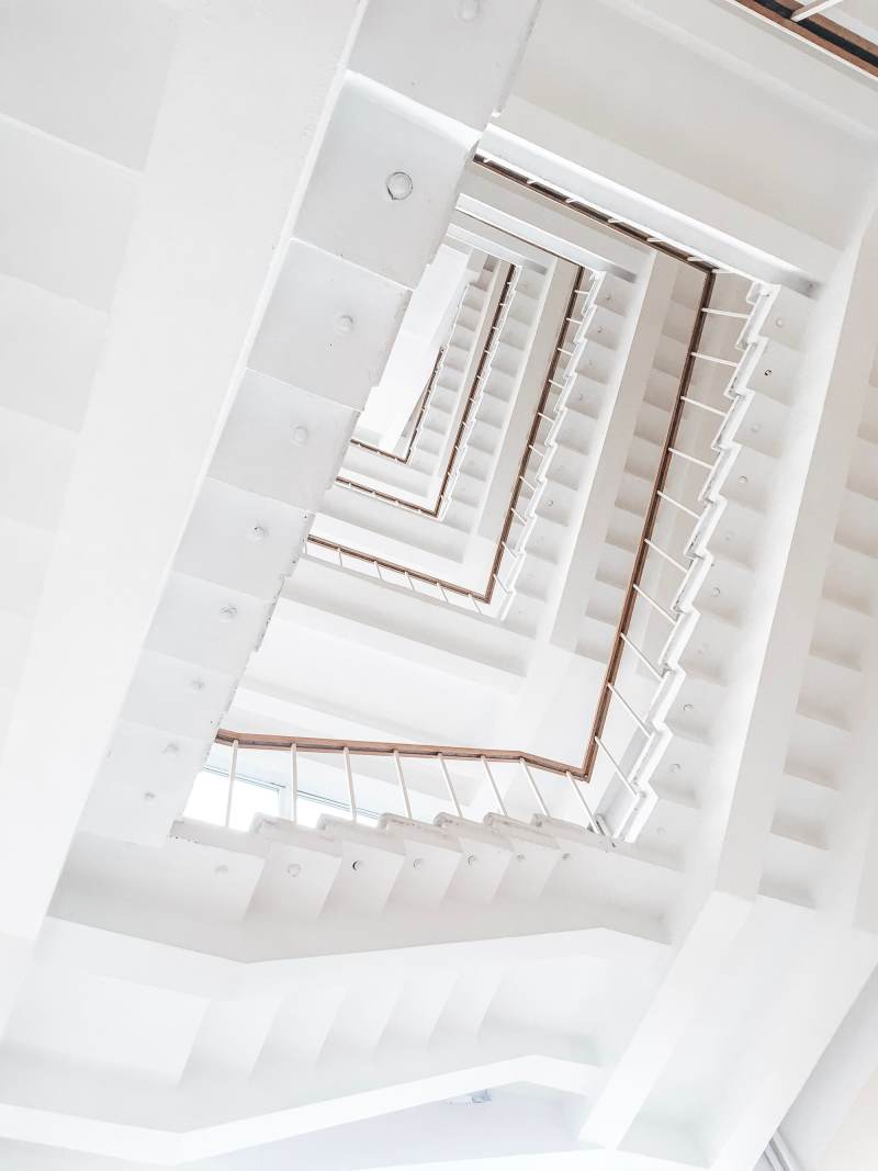 A white stair well seen from below
