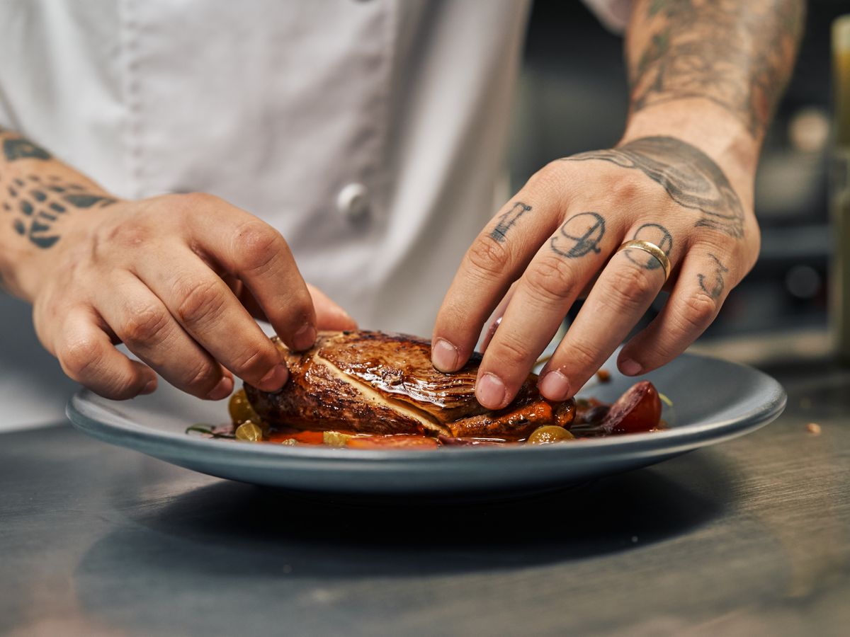 Chef plating a dish in the kitchen