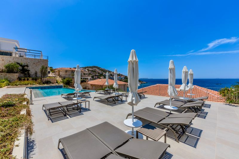 Sun loungers and parasols on a terrace above the sea