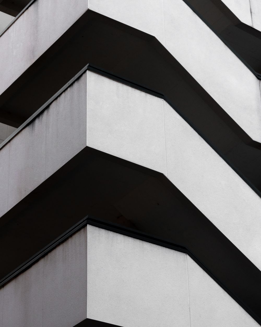 Stacked concrete balconies photographed in black and white
