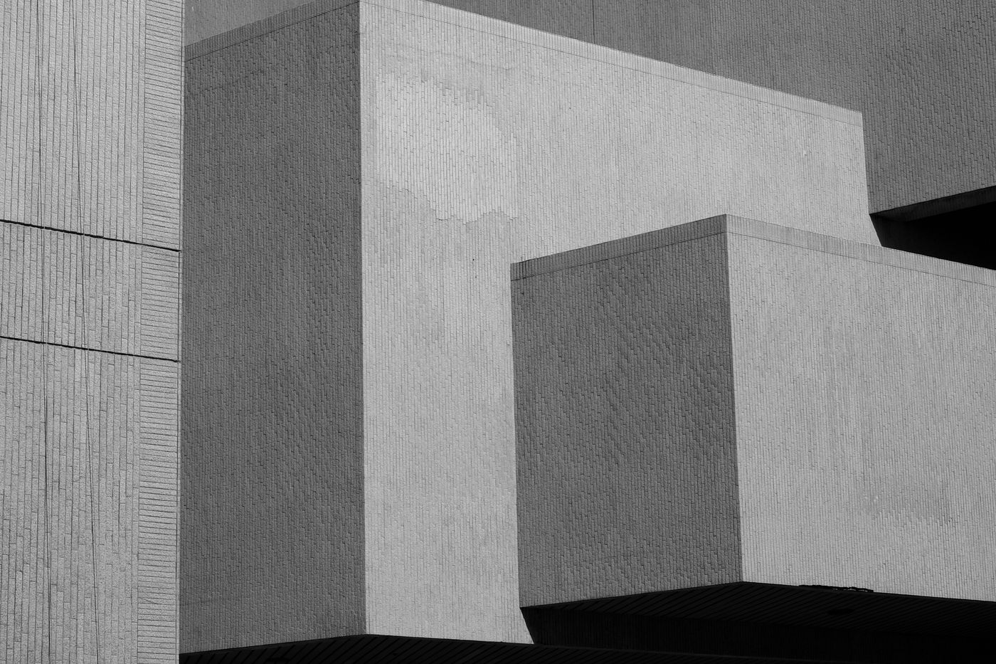 A brutalist concrete building with interlocking blocks in black and white